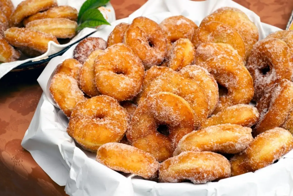 Basket with delicious fatti fritti, traditional fried donuts produced in Sardinia, typical carnival dessert, Italian food