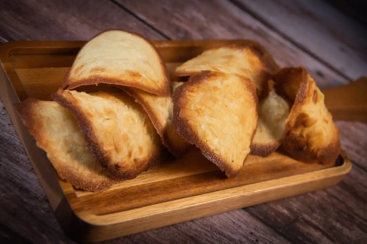 French delicacy pastry tuile with almond on wood background